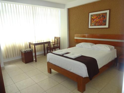 a bedroom with a large bed and a window at Torreblanca Hotel in Ilo