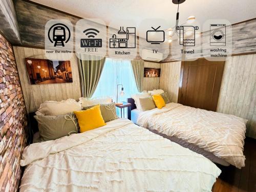 two beds in a room with posters on the walls at 603 Koiwa Disneyland Airport direct bus in Tokyo