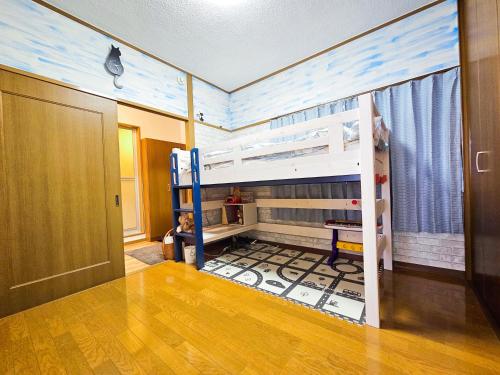 a room with two bunk beds and a hallway at 603 Koiwa Disneyland Airport direct bus in Tokyo