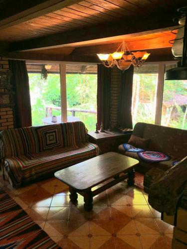 a living room with a couch and a coffee table at Будинки рибалки in Sudovaya Vishnya