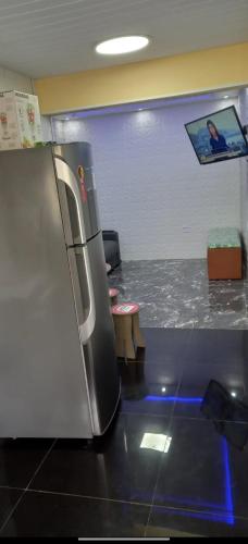 a refrigerator sitting in a room with a counter at kitnet próximo a praia in Rio de Janeiro
