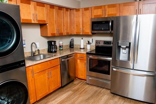 a kitchen with wooden cabinets and stainless steel appliances at Entire Home in North Potomac in Potomac