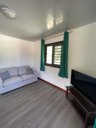 a living room with a couch and a piano at Parea Lodge Huahine BUNGALOW F2 #Miti in Parea