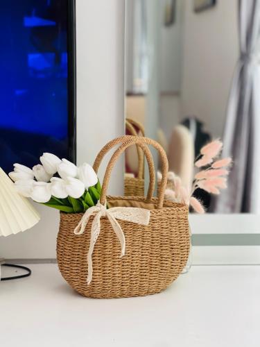 a basket with flowers in it on a table at Homestay My Ny Đà Lạt in Khu Chi Lăng