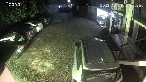 a car parked in a yard next to a house at Oasis by Franklin Hotel Boutique in Fortuna