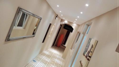 a hallway with a mirror and a red door at Pansion River in Sarajevo