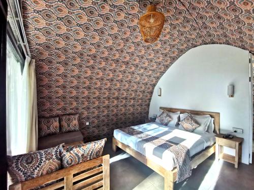 a bedroom with a bed and a wall covered in wallpaper at NIVADOO RESORT SIGIRIYA in Sigiriya