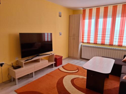 a living room with a large flat screen tv at Dima's place in Kazanlŭk