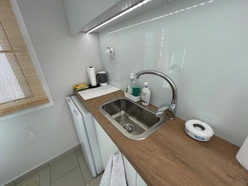 a small kitchen with a sink and a counter at Roof top studio in Patra