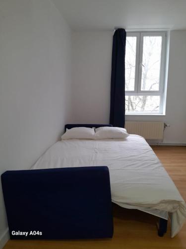 a large bed in a room with a window at The Boulevard Apartment sleeps 4 in Brussels