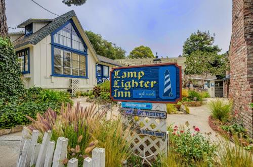 a sign for a yard lighter inn in front of a house at Lamp Lighter Inn and Sunset Suites in Carmel