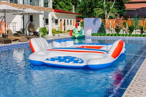 a pool with two inflatables in a swimming pool at Sonrisa Resort De Playa by Hiverooms in San Remigio