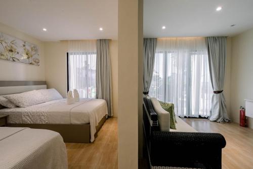 a hotel room with two beds and a window at Sonrisa Resort De Playa by Hiverooms in San Remigio