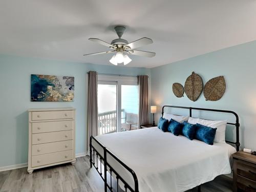 ガルフ・ショアーズにあるThe Sands #120のベッドと天井扇風機のある寝室