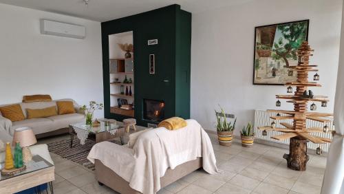 a living room with a couch and a fireplace at The Mountain House in Ktima