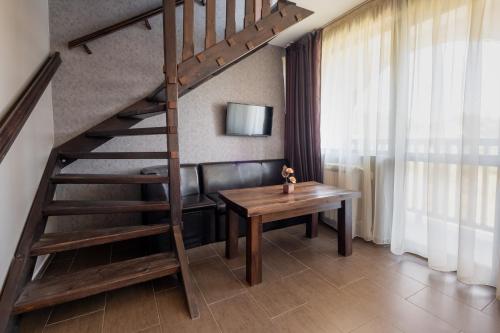 a staircase in a room with a table and a desk at Katalina SPA Resort in Tsigov Chark