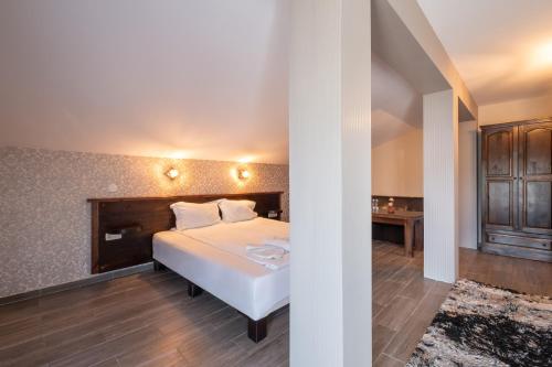 a bedroom with a white bed and a desk at Katalina SPA Resort in Tsigov Chark