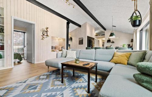 a living room with a couch and a table at 4 Bedroom Gorgeous Home In Glesborg in Glesborg