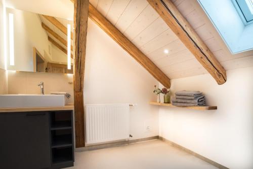 a bathroom with a sink and a window at Ferienwohnung Rohrmoser in Bad Oberdorf