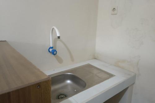 庫塔的住宿－SPOT ON 93724 Songgong Homestay，浴室内白色的柜台上的水槽