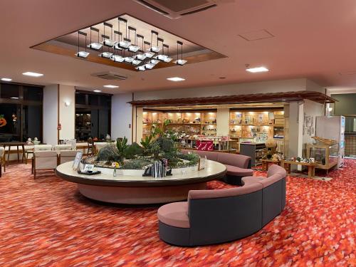 a lobby with couches and a table in a store at Yunominesou in Hongu