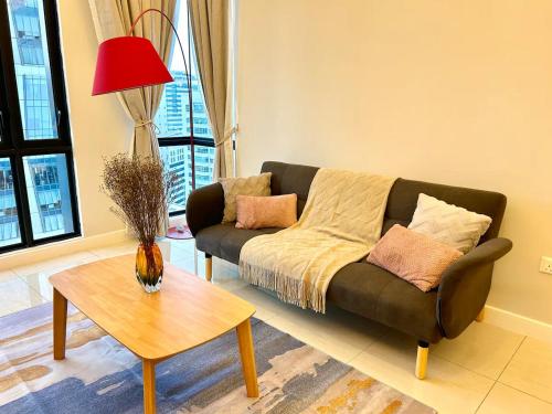 a living room with a couch and a table at SS KL Sentral by NomadNest in Kuala Lumpur