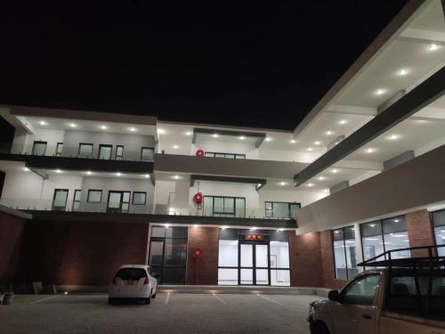 a car parked in a parking lot in front of a building at City Centre Hotel in Walvis Bay