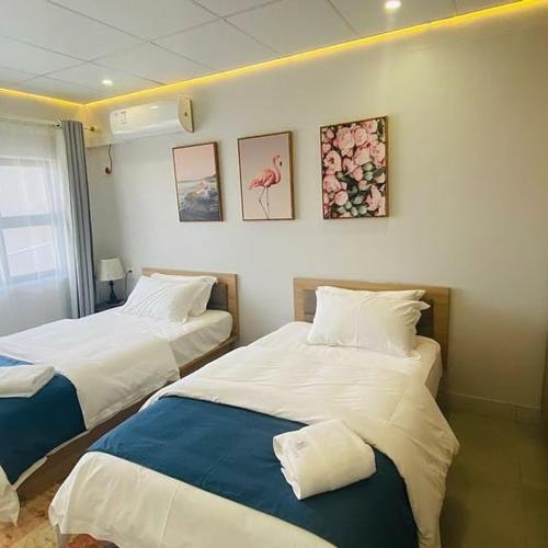 two beds sitting next to each other in a room at City Centre Hotel in Walvis Bay