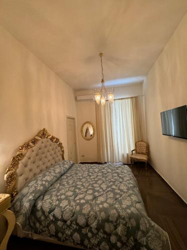 a bedroom with a bed and a chandelier at beb Mariafrancesca in Naples