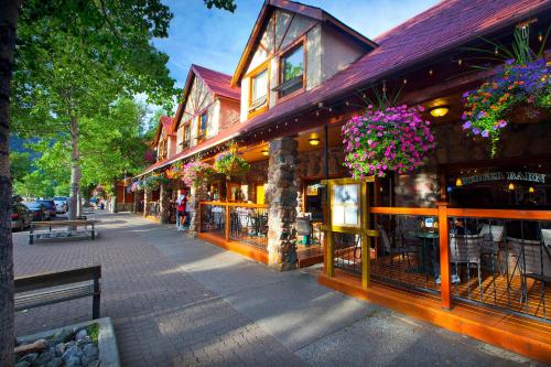 a building with flowers hanging from it on a street at Bayshore Inn & Spa in Waterton Park