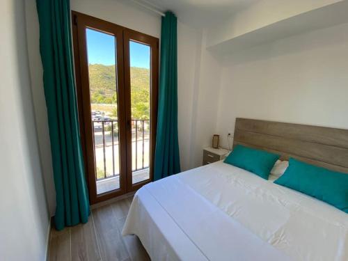 a bedroom with a bed and a large window at Apartamentos LOSA RURAL 