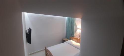 a small white room with a bed and a window at Lunis in Geghanist