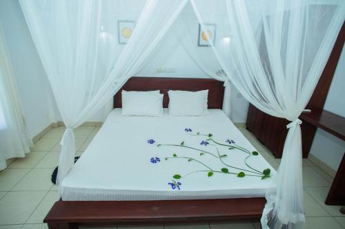 A bed or beds in a room at Ocean of Life Ayurveda Hotel