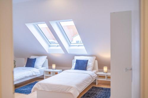 a room with two beds and two skylights at Nice Apartment in Blankenfelde-Mahlow in Blankenfelde