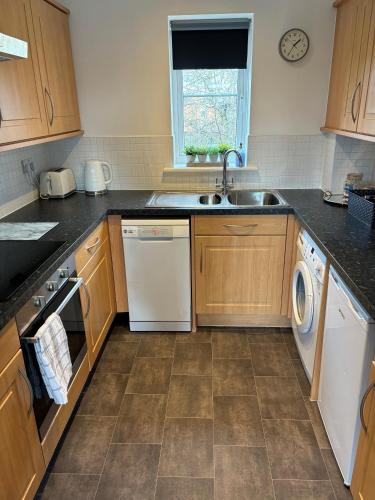 a kitchen with a sink and a dishwasher at Cathedral Apartment in Lichfield