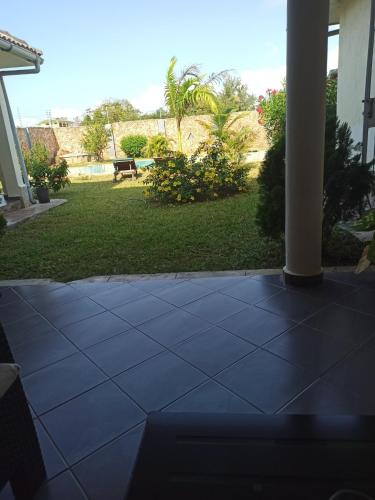 a view of a patio with a grass yard at Lisa Mari in Mombasa