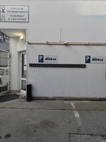 a white building with a sign on the side of it at APARTIA Skořepka, Brno-centrum in Brno