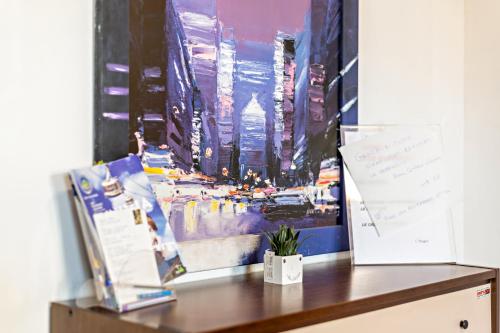a desk with a painting of a city at Vacanze Francesca in Bussolengo