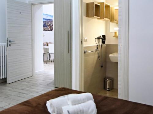 a room with a bed and a bathroom at Relais Villa Borghese in Rome