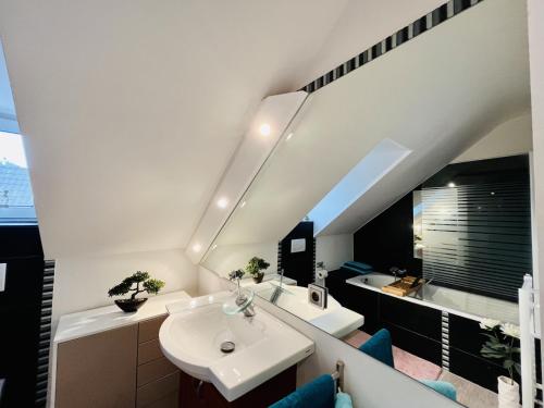 a bathroom with a sink and a bath tub at 3SZ Penthaus Luna am Sandstrand mit Meerblick & Balkon in Lübeck