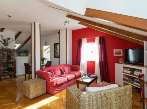 a living room with a red couch and chairs at Apartment Lukre Mala in Dubrovnik