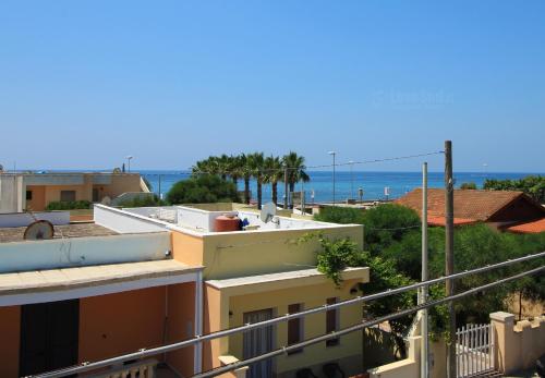 a view of the ocean from the balcony of a building at Marea Casa Spiaggia by LoveSud in Torre Vado