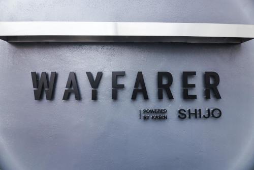 a sign on the side of a building with the word warrior at WAYFARER Kyoto Shijo in Kyoto