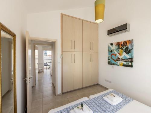 a bedroom with a bed and a large closet at Villa Nora in Protaras