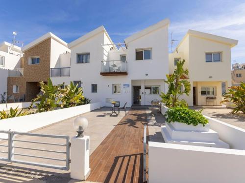 a villa with a view of the courtyard of a house at Villa Nora in Protaras