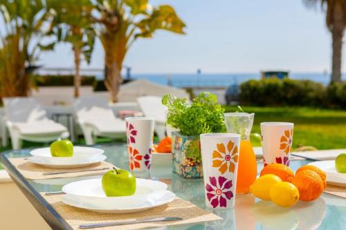 a table with plates of fruit on top of it at Villa Nora in Protaras