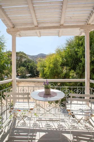 a patio with a table and chairs on a balcony at Hotel Irini in Livadia