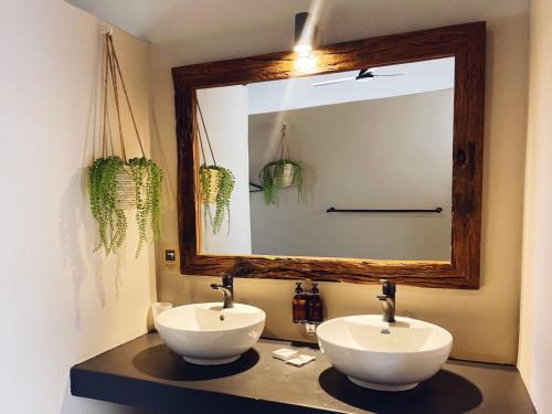 a bathroom with two sinks and a large mirror at The Baobab Bush Lodge and Villa in Hoedspruit