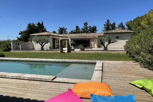 a backyard with a swimming pool and a house at Beautiful contemporary villa swimming pool and large garden in Berre-lʼÉtang