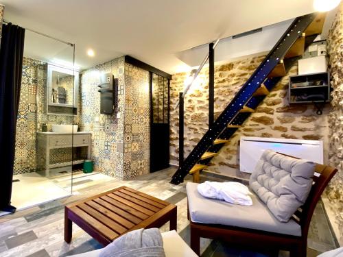 a living room with a couch and a staircase at #SPA Wellness @ Paris 11ème in Paris